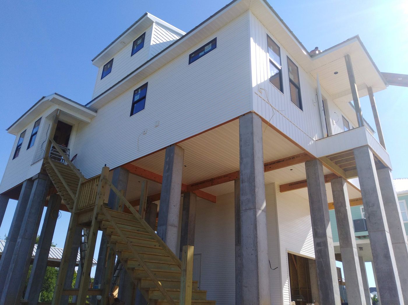 Raised home with new siding, trim and a wood staircase